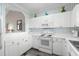Bright kitchen with white cabinets, modern appliances, and unique decor at 5751 Oyster Catcher Dr. # 334, North Myrtle Beach, SC 29582