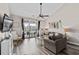 Bright living room showcases vaulted ceilings, ceiling fan, stylish decor and sliding glass doors to the balcony at 5751 Oyster Catcher Dr. # 334, North Myrtle Beach, SC 29582