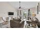 Comfortable living room with vaulted ceiling, fan, stylish furniture, and access to a balcony with a view at 5751 Oyster Catcher Dr. # 334, North Myrtle Beach, SC 29582