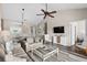 Spacious living area with wood floors, comfortable seating, TV, and open access to a dining area and kitchen at 5751 Oyster Catcher Dr. # 334, North Myrtle Beach, SC 29582