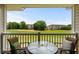Outdoor patio with seating overlooking a lush green golf course at 5751 Oyster Catcher Dr. # 334, North Myrtle Beach, SC 29582