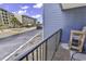 Balcony overlooking the parking lot, showing the building's blue exterior at 5905 South Kings Hwy. # 135, Myrtle Beach, SC 29575