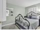 Serene bedroom with a decorative iron bed frame, neutral walls, and shuttered windows for a relaxing retreat at 5905 South Kings Hwy. # 135, Myrtle Beach, SC 29575