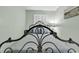 Close-up of a cozy bedroom featuring a decorative iron bed frame and soft, neutral bedding for a peaceful rest at 5905 South Kings Hwy. # 135, Myrtle Beach, SC 29575