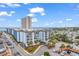 Resort exterior features a blue facade, palm trees, balconies, covered drive, and convenient parking in a coastal setting at 5905 South Kings Hwy. # 135, Myrtle Beach, SC 29575
