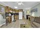 View of the kitchen area opening to the living space, with wood cabinets and standard appliances at 5905 South Kings Hwy. # 135, Myrtle Beach, SC 29575