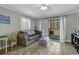 Cozy living room with light walls, tiled floor, and access to a balcony at 5905 South Kings Hwy. # 135, Myrtle Beach, SC 29575