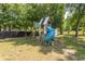 Backyard with playground equipment, storage building, and mature shade trees at 601 Blue Daisy Ct., Loris, SC 29569