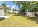 Large backyard with a storage shed, slide, and a black fence surrounding the property at 601 Blue Daisy Ct., Loris, SC 29569