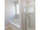 Bathroom featuring soaking tub and a walk-in shower with sliding glass doors at 601 Blue Daisy Ct., Loris, SC 29569