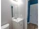 Small vanity with framed mirror and a door leading to another room at 601 Blue Daisy Ct., Loris, SC 29569