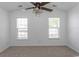 Spacious bedroom featuring a vaulted ceiling, plush carpeting, and ample natural light from two windows at 601 Blue Daisy Ct., Loris, SC 29569
