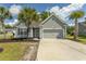 Charming single-story home featuring a manicured front yard, attached garage, and classic gray siding at 601 Blue Daisy Ct., Loris, SC 29569
