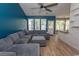 Cozy living room with a large sectional sofa, modern ceiling fan, and open layout at 601 Blue Daisy Ct., Loris, SC 29569