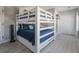 Bedroom showcasing bunk beds with blue bedding, a closet, and light wood flooring, maximizing space at 6095 Catalina Dr. # 1613, North Myrtle Beach, SC 29582