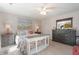 Bright bedroom featuring a ceiling fan, stylish furniture, and beach-themed decor, creating a relaxing coastal vibe at 6095 Catalina Dr. # 1613, North Myrtle Beach, SC 29582