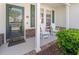Inviting front porch with seating, decorative door, and brick accents at 6095 Catalina Dr. # 1613, North Myrtle Beach, SC 29582