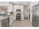 Modern kitchen with granite counters, white cabinets, and stainless-steel appliances at 6095 Catalina Dr. # 1613, North Myrtle Beach, SC 29582