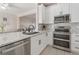 Modern kitchen with granite counters, white cabinets, and stainless-steel appliances at 6095 Catalina Dr. # 1613, North Myrtle Beach, SC 29582