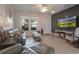 Comfortable living room features hardwood floors, a ceiling fan, and modern wall accents at 6095 Catalina Dr. # 1613, North Myrtle Beach, SC 29582