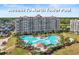 Large community pool at North Tower with palm trees and lounge chairs, offering a luxurious retreat at 6095 Catalina Dr. # 1613, North Myrtle Beach, SC 29582