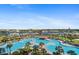 Stunning elevated view of large community pool with palm trees and a nearby marina at 6095 Catalina Dr. # 1613, North Myrtle Beach, SC 29582