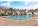 Outdoor community pool surrounded by brick with lounge chairs and a wrought-iron fence at 6095 Catalina Dr. # 1613, North Myrtle Beach, SC 29582
