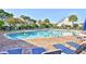 Outdoor community pool surrounded by brick with lounge chairs and umbrellas at 6095 Catalina Dr. # 1613, North Myrtle Beach, SC 29582