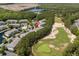 A beautiful aerial view shows a community with a pond, pool, parking, and golf course nearby at 6253 Catalina Dr. # 422, North Myrtle Beach, SC 29582