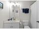 Bright bathroom with a white vanity, toilet, and a mirrored cabinet at 6253 Catalina Dr. # 422, North Myrtle Beach, SC 29582