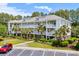 Beautiful three-story condo building with palm trees, landscaping, and private balconies at 6253 Catalina Dr. # 422, North Myrtle Beach, SC 29582