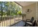 Charming screened porch with an outdoor seating area and a peaceful wooded view at 6253 Catalina Dr. # 422, North Myrtle Beach, SC 29582