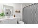 Modern bathroom featuring a sink with white vanity, decorative mirror, and shower with patterned curtain at 627 Culmen Ct., Myrtle Beach, SC 29588