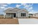 Charming single-story home with gray siding, black shutters, and a well-manicured lawn on a sunny day at 631 Culmen Ct., Myrtle Beach, SC 29588
