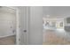 Open-concept interior view with a laundry closet, gray cabinets, wood-look floors, and plenty of natural light at 631 Culmen Ct., Myrtle Beach, SC 29588