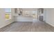 Modern kitchen features stainless steel appliances, gray cabinets, light countertops, and wood-look flooring at 631 Culmen Ct., Myrtle Beach, SC 29588