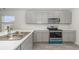 Well-lit kitchen featuring stainless steel appliances, gray cabinets, white countertops, and wood-look floors at 631 Culmen Ct., Myrtle Beach, SC 29588