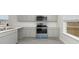 Kitchen with gray cabinets, white countertops, stainless steel appliances, and an open doorway to the living space at 631 Culmen Ct., Myrtle Beach, SC 29588