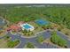 Aerial view showcasing the community pool, clubhouse, tennis courts, playground, and ample parking at 631 Edgecreek Dr., Myrtle Beach, SC 29579