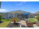 A spacious backyard features a stone patio, lush green lawn, and outdoor seating area, perfect for entertaining at 631 Edgecreek Dr., Myrtle Beach, SC 29579