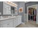 A stylish bathroom featuring a double sink vanity, a large mirror, and a walk-in closet at 631 Edgecreek Dr., Myrtle Beach, SC 29579