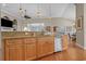 Open eat-in kitchen with stainless appliances, granite counters, wood cabinets, island, and hardwood floors at 631 Edgecreek Dr., Myrtle Beach, SC 29579