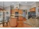 Eat-in kitchen featuring wood cabinets, granite countertops, kitchen island, and stainless steel appliances at 631 Edgecreek Dr., Myrtle Beach, SC 29579