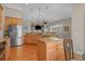 Open eat-in kitchen with stainless appliances, granite counters, wood cabinets, island, and hardwood floors at 631 Edgecreek Dr., Myrtle Beach, SC 29579