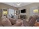 Cozy living room with comfortable seating, built-in cabinets, a ceiling fan, and large-screen television at 631 Edgecreek Dr., Myrtle Beach, SC 29579