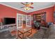 Comfortable living room with hardwood floors, entertainment center, and a view into another room through french doors at 631 Edgecreek Dr., Myrtle Beach, SC 29579