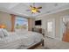 A spacious main bedroom showcases a tray ceiling, large window, carpet, and access to outdoor living at 631 Edgecreek Dr., Myrtle Beach, SC 29579