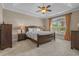 The main bedroom features a tray ceiling, carpet, furnishings, and a large window at 631 Edgecreek Dr., Myrtle Beach, SC 29579