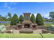 Inviting outdoor fireplace with seating area overlooking the water and lush landscaping at 631 Edgecreek Dr., Myrtle Beach, SC 29579