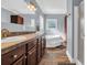 Bathroom featuring double sink vanity, soaking tub, and separate shower with updated fixtures at 6357 Highway 707, Myrtle Beach, SC 29588